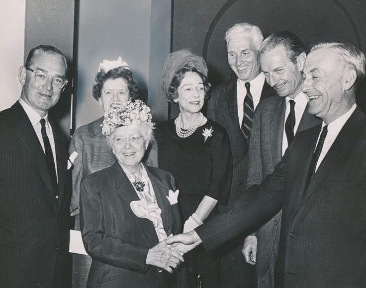 This is an image of a black and white photograph of six people dressed for a formal dinner or party. This is judged by the...